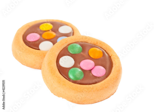 Biscuits with milk chocolate and coloured chocolate beans isolat