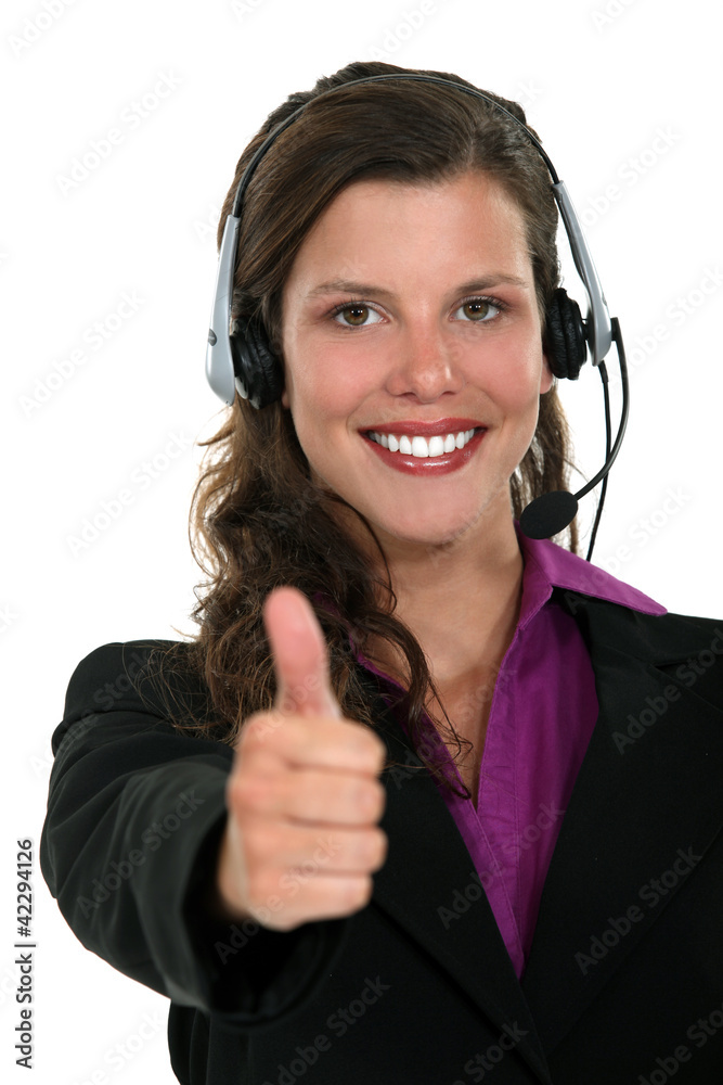 Brunette call-center worker giving the thumbs-up Brunette call-center worker giving the thumbs-up
