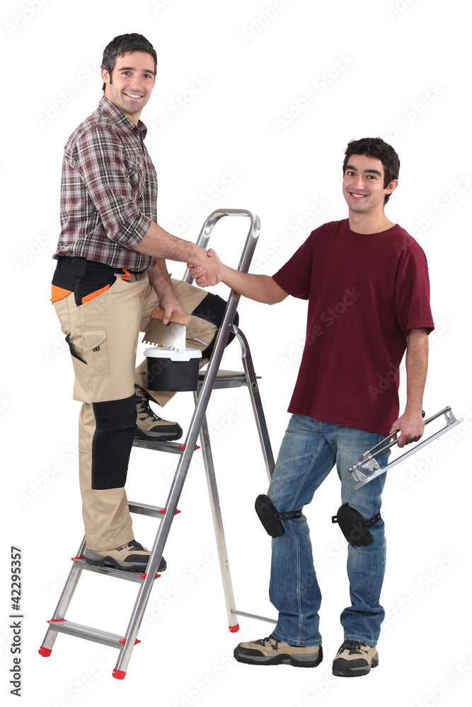 craftsman and apprentice shaking hands craftsman and apprentice shaking hands