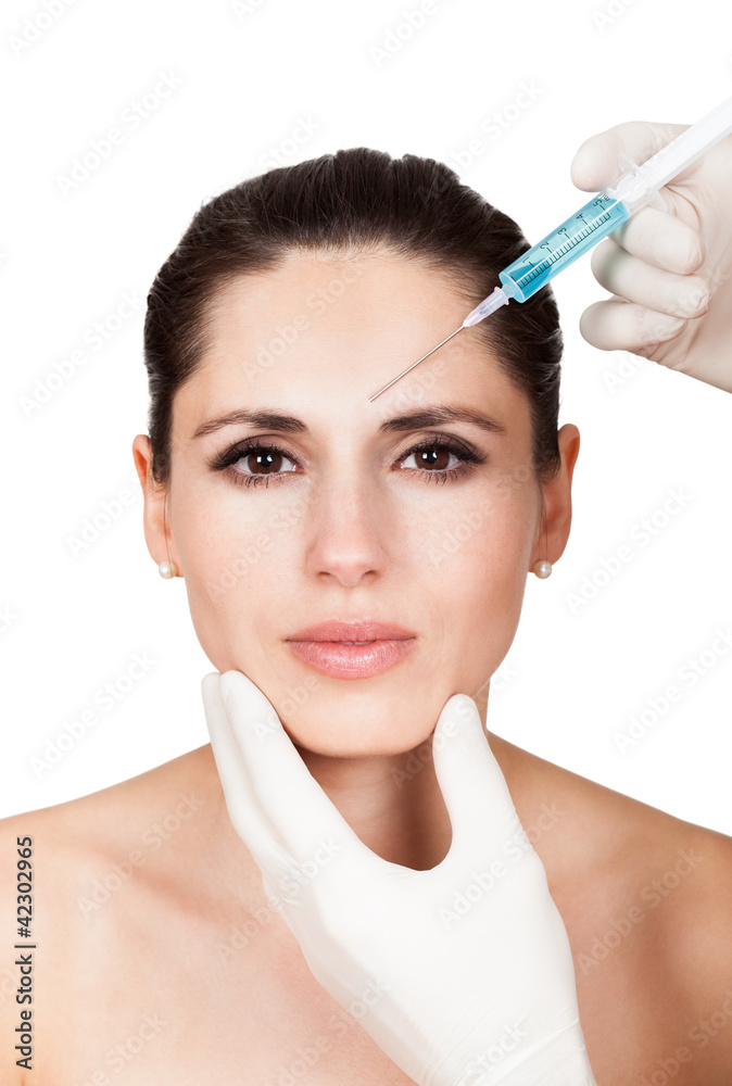 Beautician doing face injection to woman