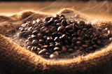 Coffee beans with smoke in burlap sack