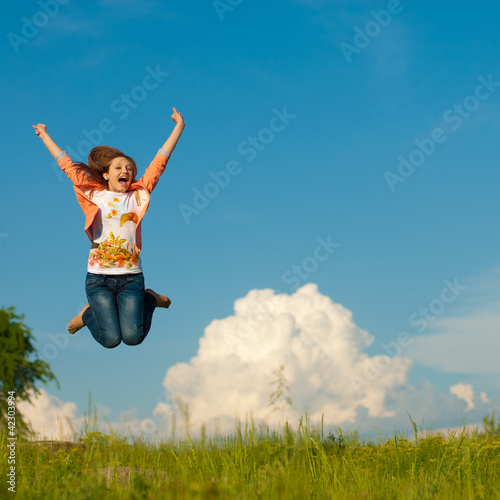 happy woman jumping up in blue sky