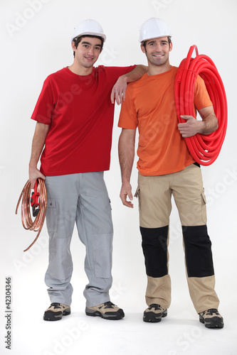 Two plumbers on white background