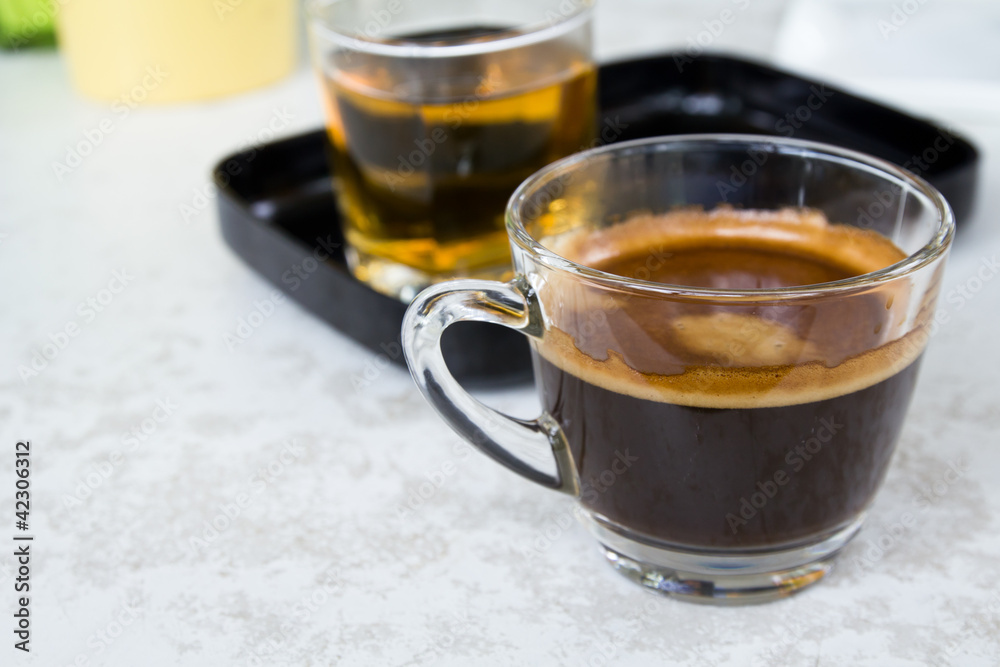 Black coffee and tea on white table