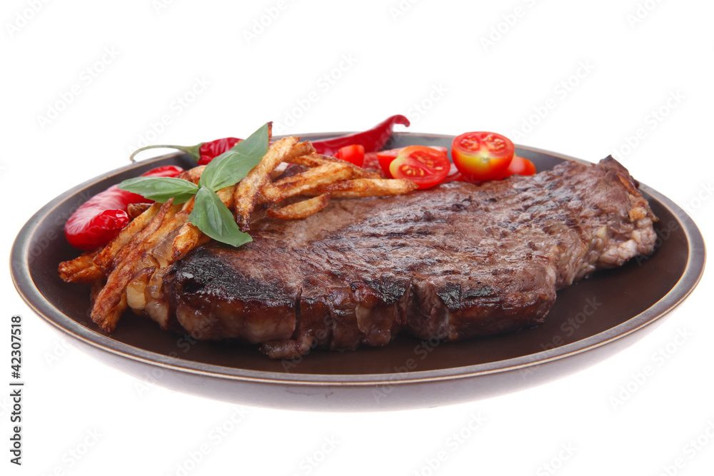 beef steak on dark plate with red hot chili pepper beef steak on dark plate with red hot chili pepper