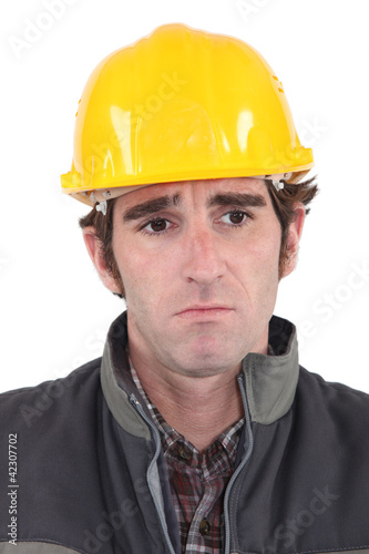 A sad construction worker.