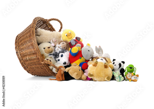 Stuffed animal toys in a basket isolated on a white background