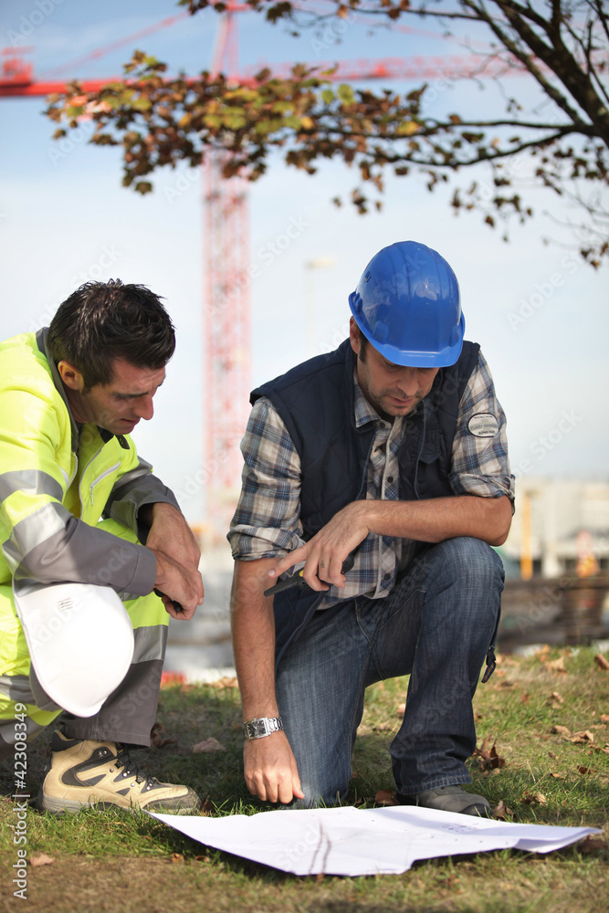 Construction workers discussing plans Construction workers discussing plans
