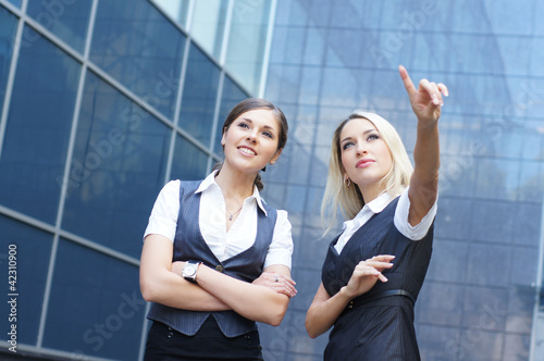 Two young and smart businesswoman in formal clothes