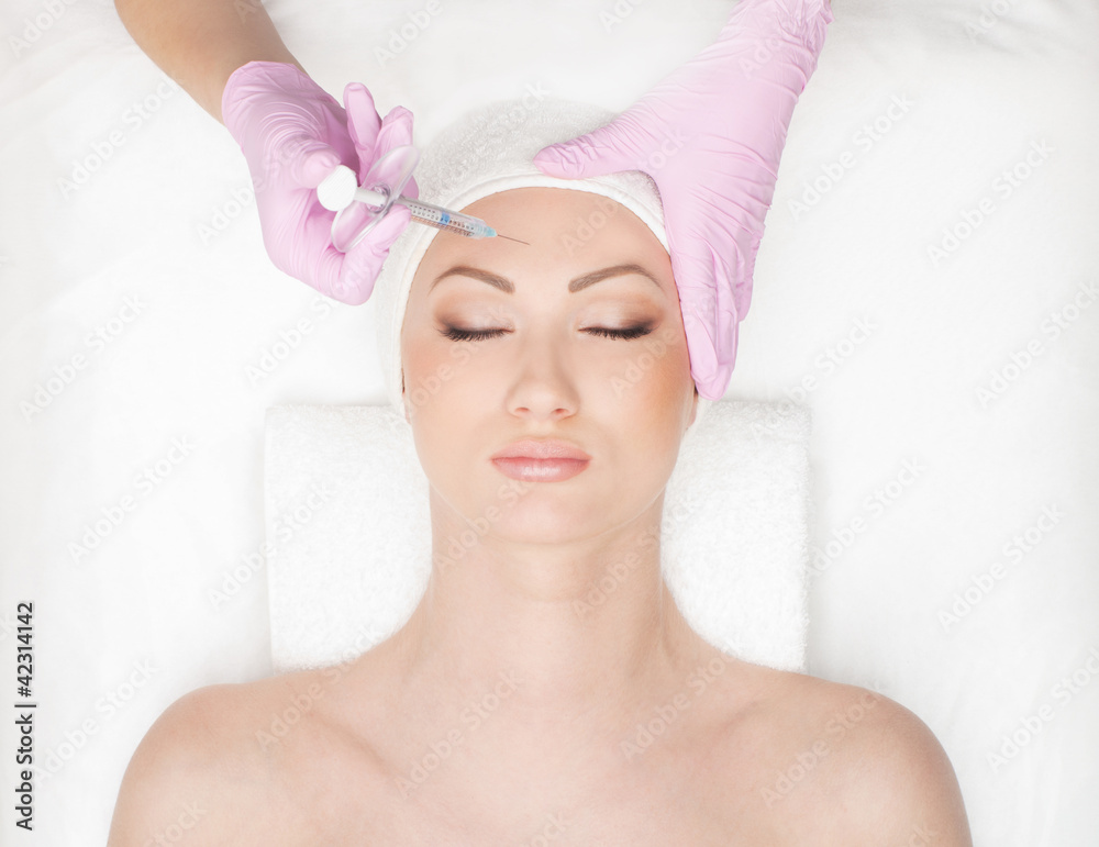 Portrait of a young woman on a botox injection procedure Portrait of a young woman on a botox injection procedure