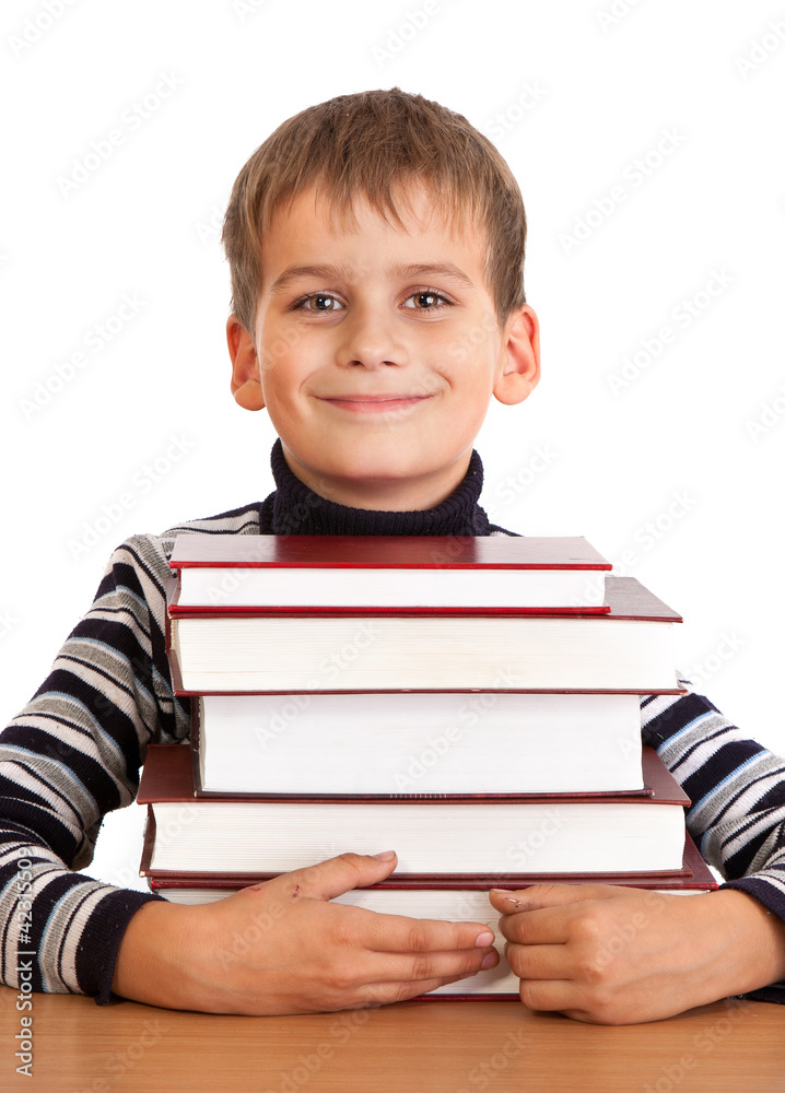 Schoolboy and a heap of books isolated on a white background Schoolboy and a heap of books isolated on a white background
