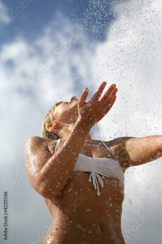Woman splashing water on herself
