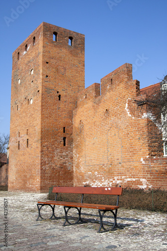 Wall of Warsaw castle and empty bench