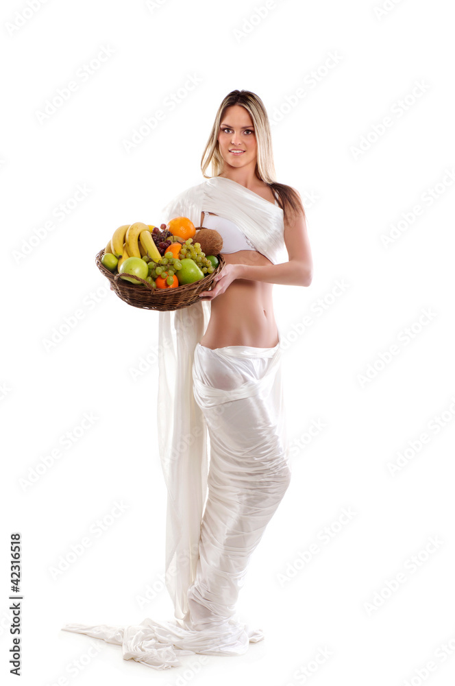 A young woman in white holding a basket full of fruits