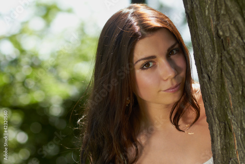 Young girl chilling in green park outdoors