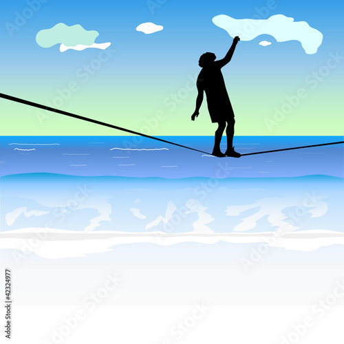 man walking on the tightrope above the sea