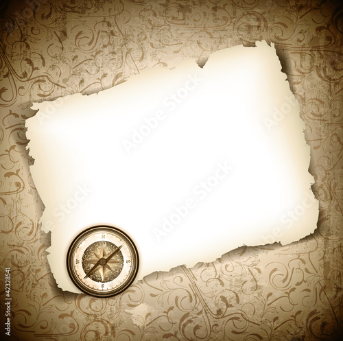 Vinatge antique compass at burned paper