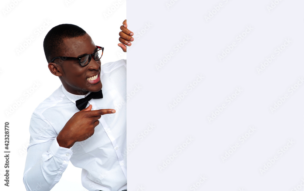 African young man pointing at blank billboard African young man pointing at blank billboard