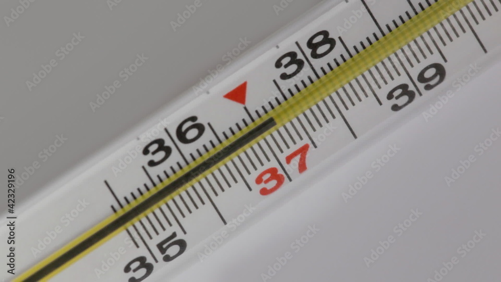 Glass mercurial thermometer on a white background