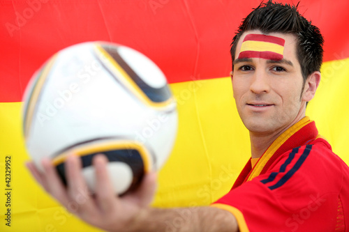 Male Spanish soccer supporter holding ball