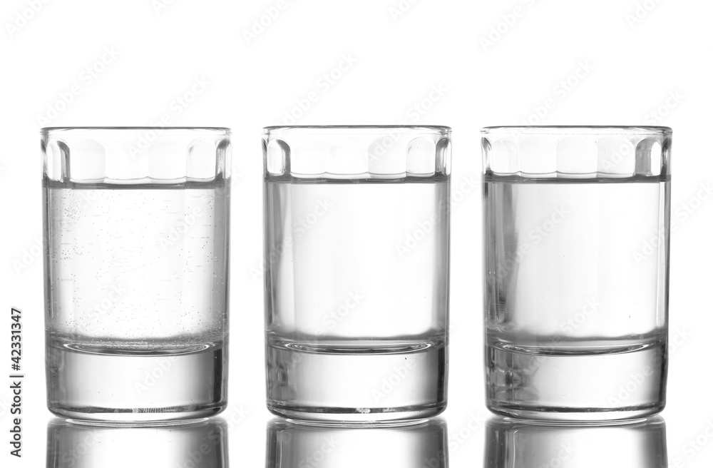 Three glass of vodka isolated on white Three glass of vodka isolated on white