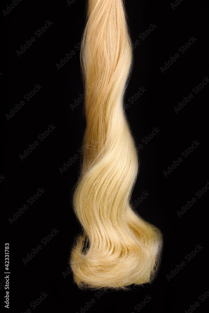 Curly blond hair isolated on black