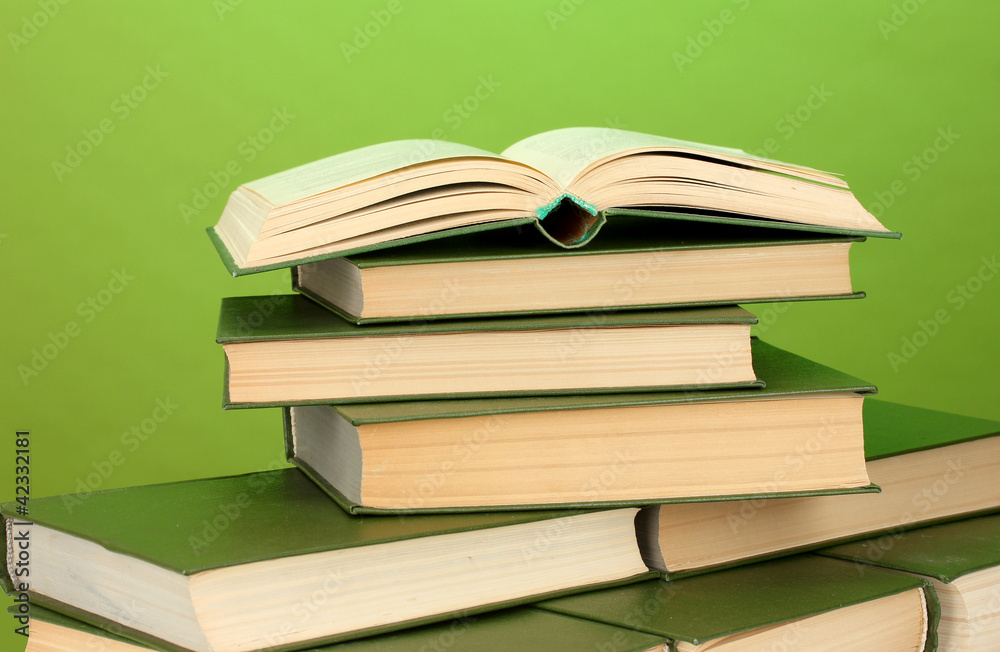 pile of books on green background close-up pile of books on green background close-up