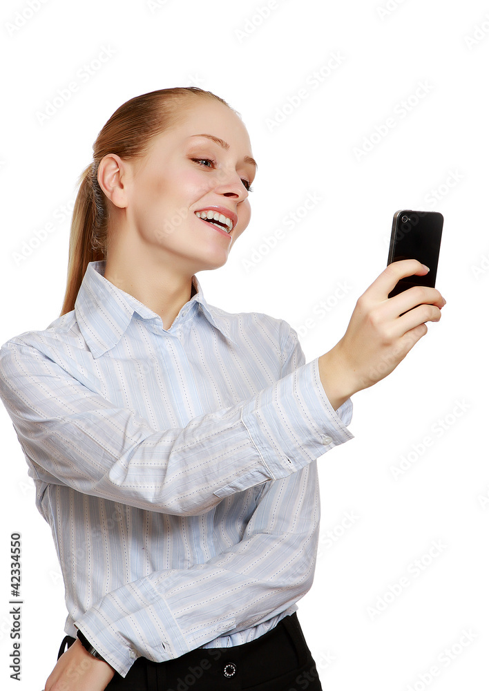 A smiling businesswoman using a mobile phone, over white A smiling businesswoman using a mobile phone, over white