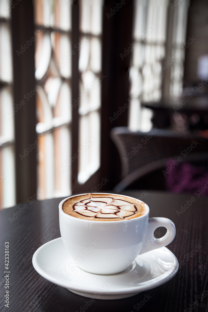 mocha coffee drink on a wood table by the window - obrazy, fototapety, plakaty 