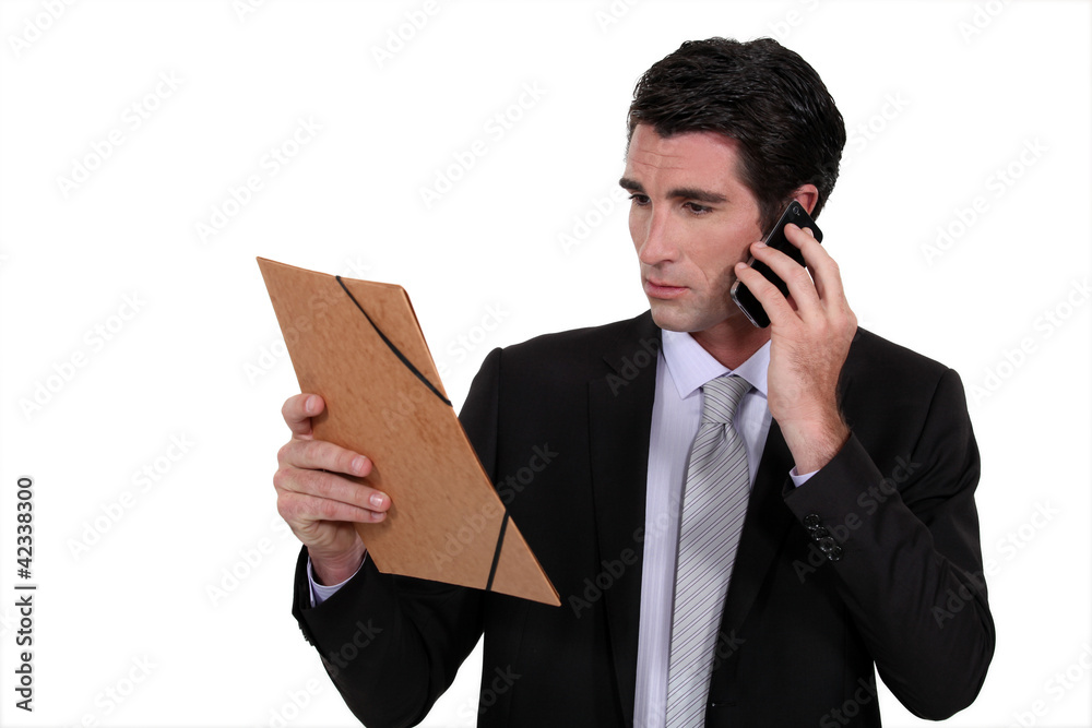 Concerned businessman talking on the phone Concerned businessman talking on the phone