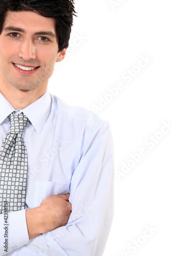 Businessman stood with arms folded