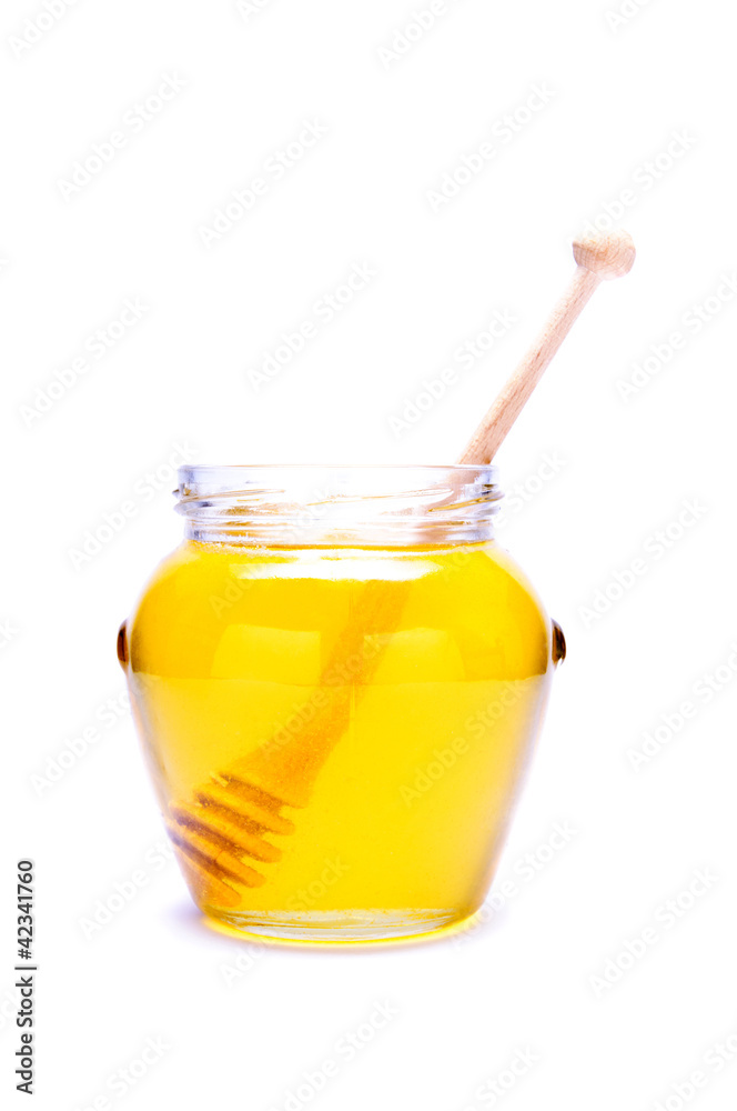 glass of honey isolated on white