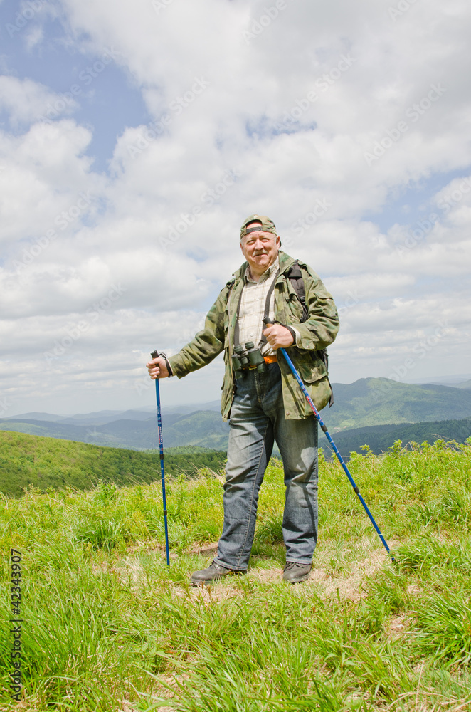 Senior birdwatcher trekking in mountains (Bieszczady, Poland)
