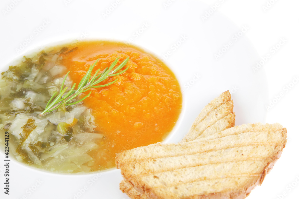 vegetable soup served with toasts on white dish