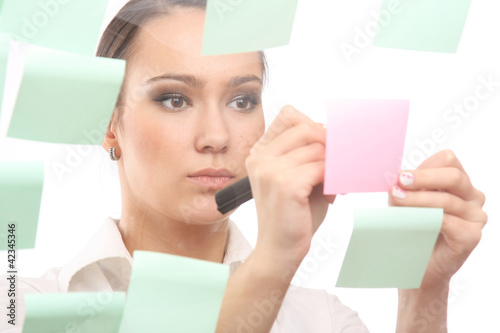 businesswoman pointing at adhesive notes on wall photo