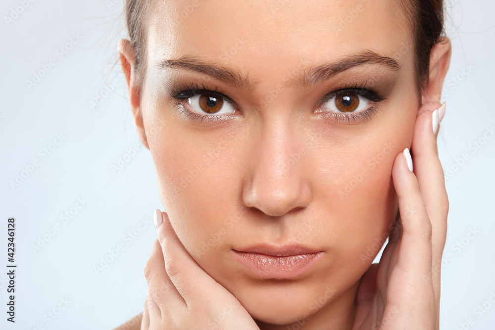 happy beautiful woman touching face and looking at camera winks happy beautiful woman touching face and looking at camera winks