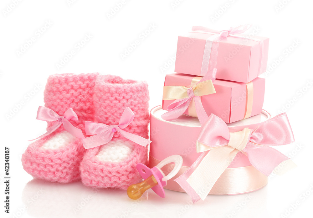 pink baby boots, pacifier and gifts isolated on white pink baby boots, pacifier and gifts isolated on white