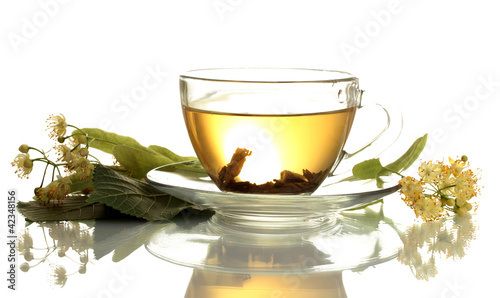 cup of linden tea and flowers isolated on white