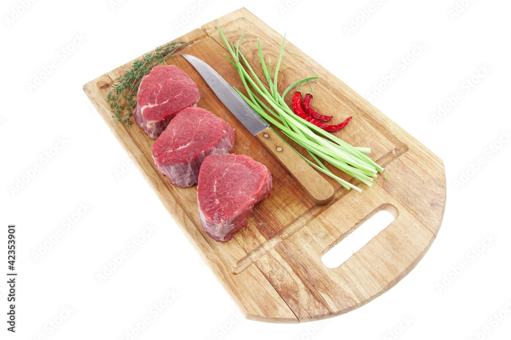raw beef fillet on wooden board