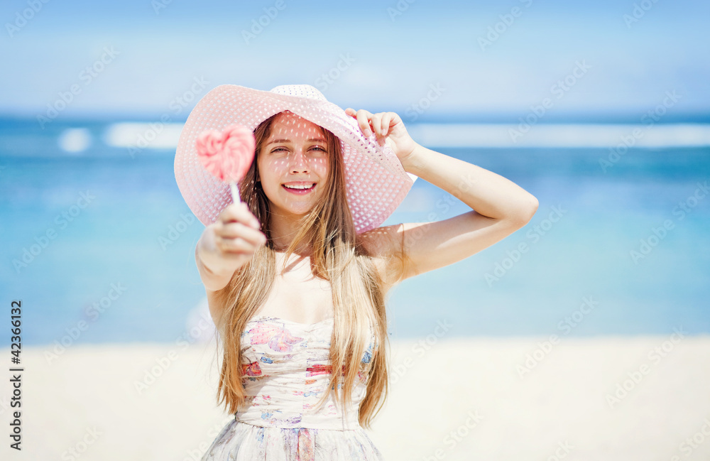 Valentine's day: Young caucasian woman holding lollipop-heart on Valentine's day: Young caucasian woman holding lollipop-heart on