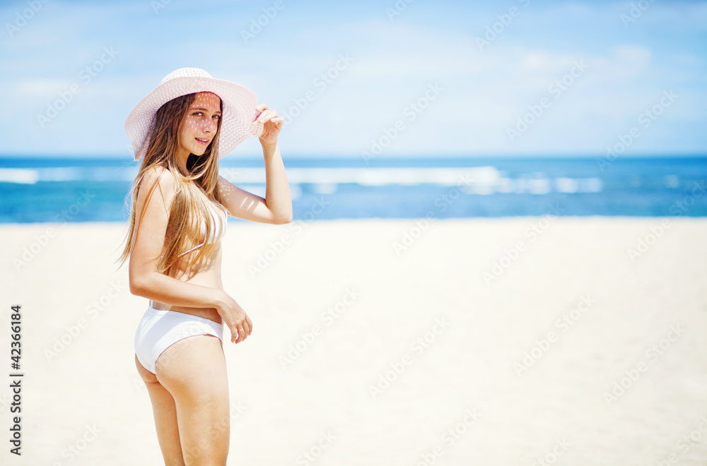 young woman in white swimsuit on the beach, bali