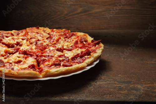 round pizza on wood background