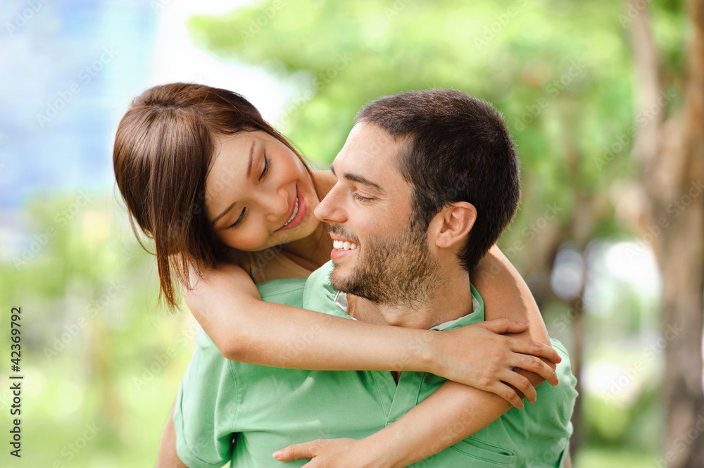 Happy girl embracing handsome male outside Happy girl embracing handsome male outside