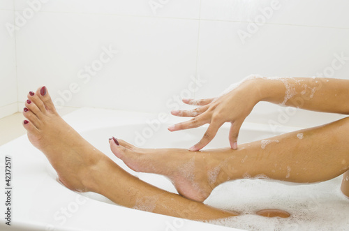 Woman is covered with a foam bath  She is taking a bath  She is © somkanokwan