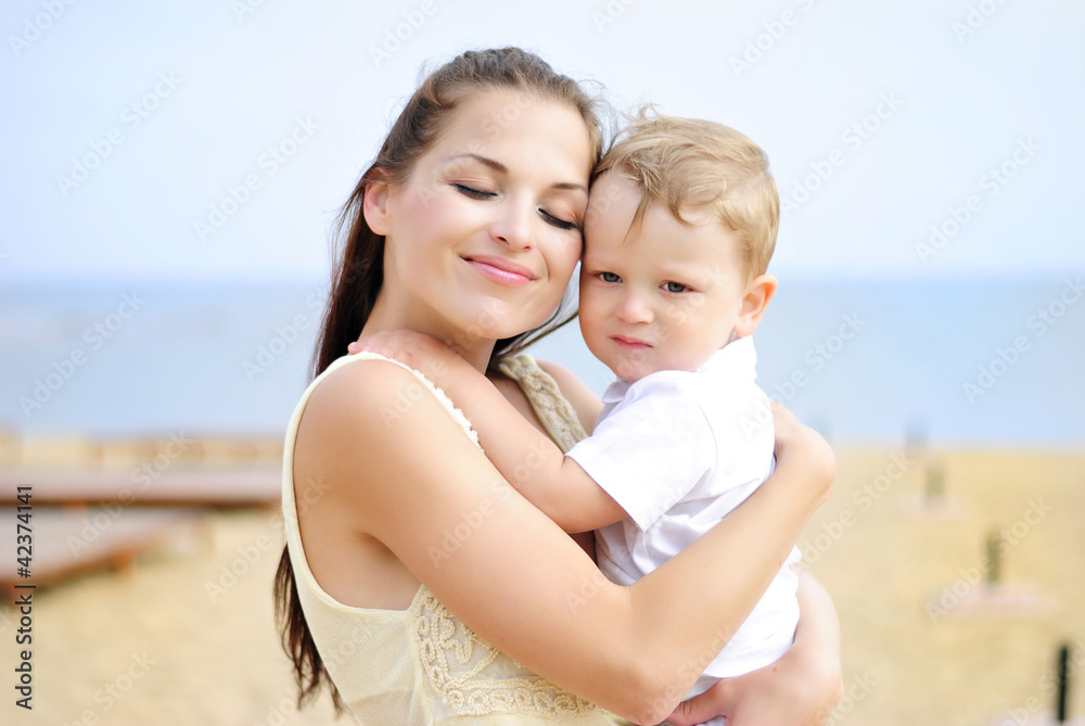 The little boy with mother on walk at the sea The little boy with mother on walk at the sea