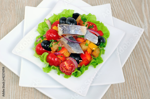 Appetizer of herring and vegetables with croutons