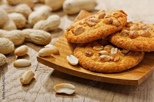 Cookies with peanuts on a square wooden plate