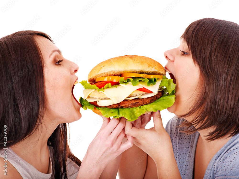 Women eating hamburger.