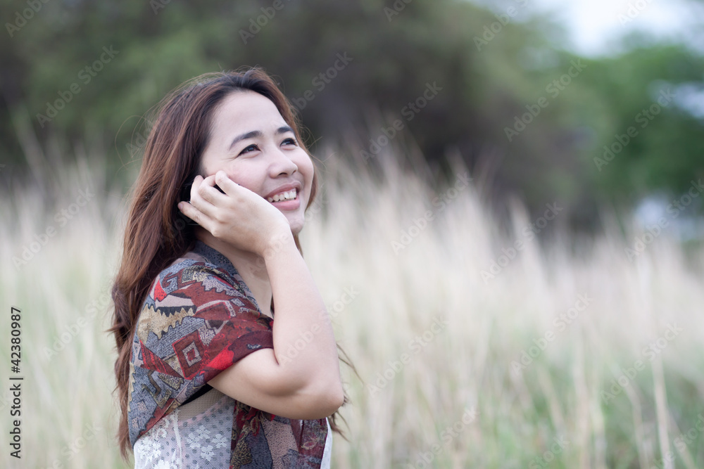 Fototapeta premium young woman talking on mobile phone
