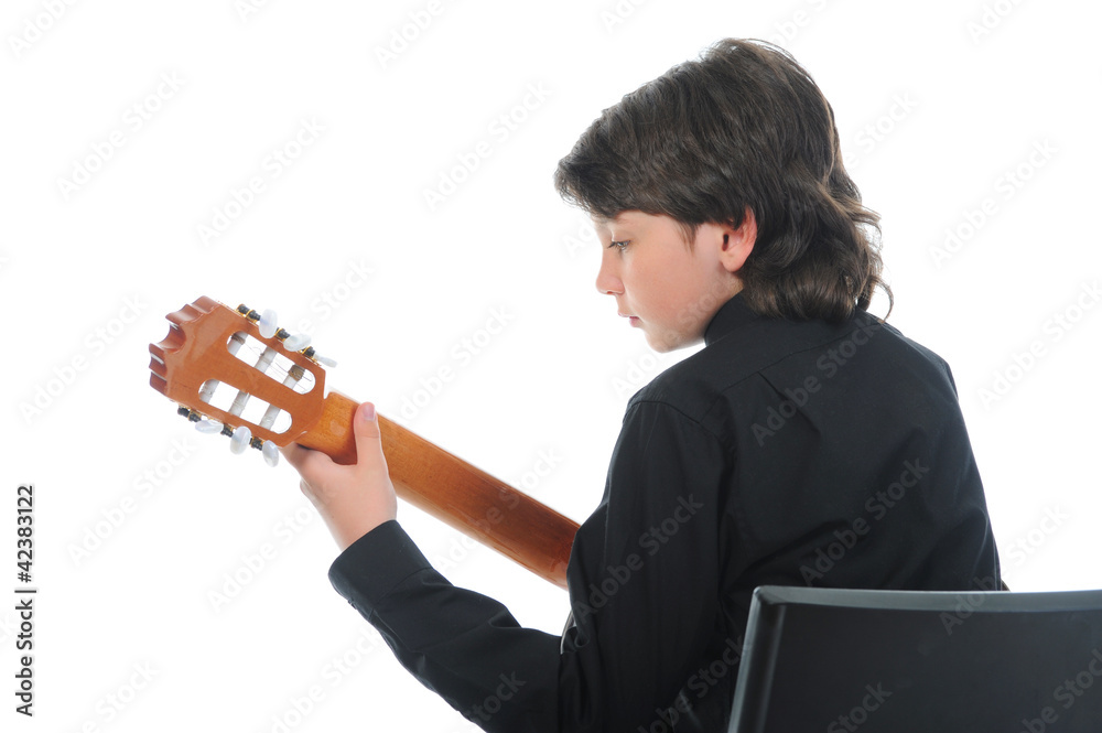 Little boy musician playing guitar